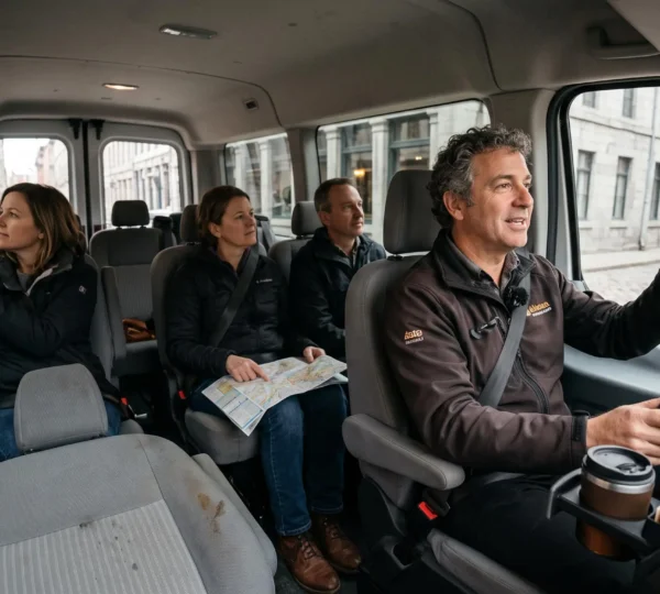 A driver narrating to passengers inside a touring van as historic stone buildings of Old Montréal pass by the windows.